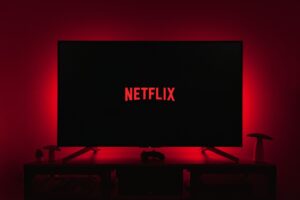 a television with the netflix logo lit up in the dark