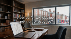 A professional desktop setup in a classic office with a laptop displaying an open email inbox on a wooden desk. A large window overlooks a blurred United Kingdom street scene featuring traditional red double-decker buses. Minimal white text in the center reads, "Applied for UK jobs but getting no response?"